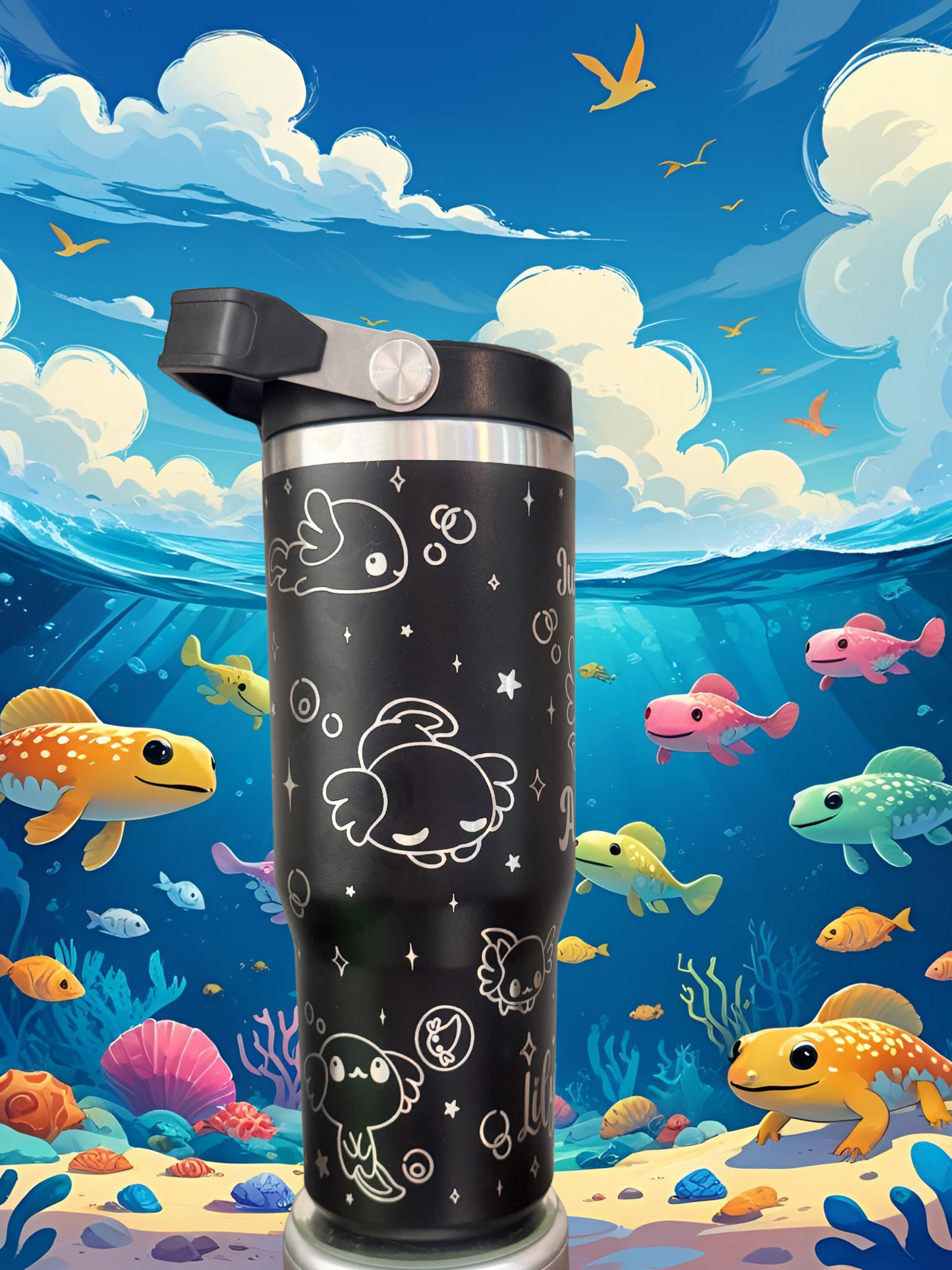 A black thermos with a whimsical design of fish and sea creatures on its surface, set against a vibrant underwater scene with colorful fish and coral.