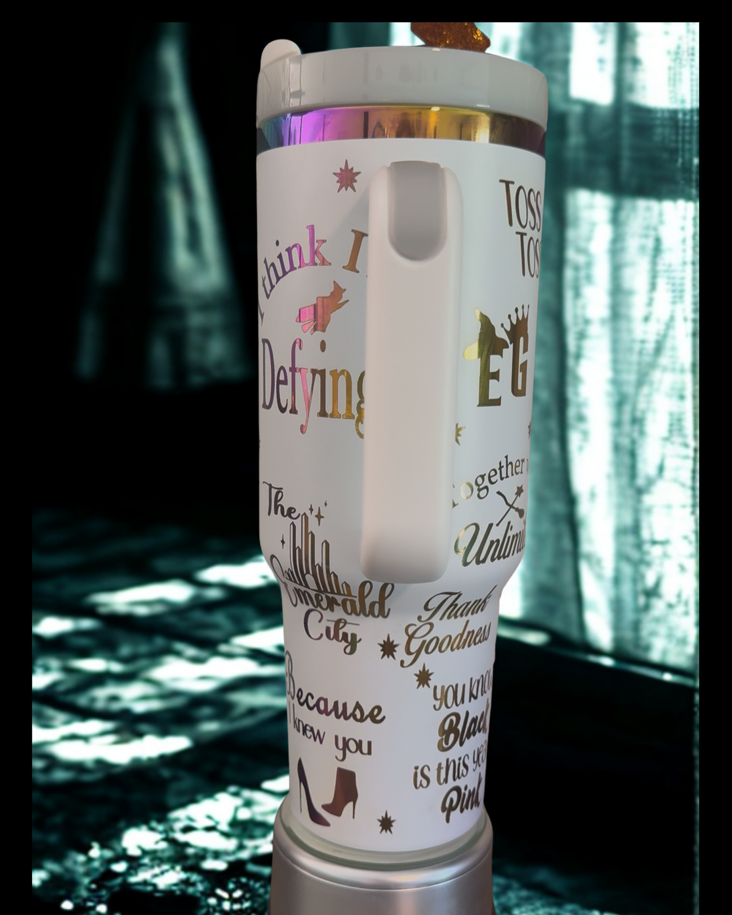 A white thermos mug with various phrases and words printed on it, including "Think I Defying", "The Star-Shaped City", "Thank goodness", "Because you know", "Blast is this year", and "Tossed to the City".
