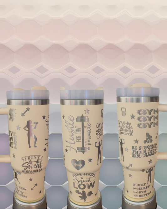 Three beige tumblers with various fitness-related text and graphics printed on them.