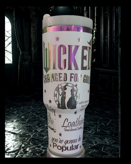 A white tumbler with a printed design featuring the text "WICKED" and "CHANGED FOR GOOD" along with various other text elements.