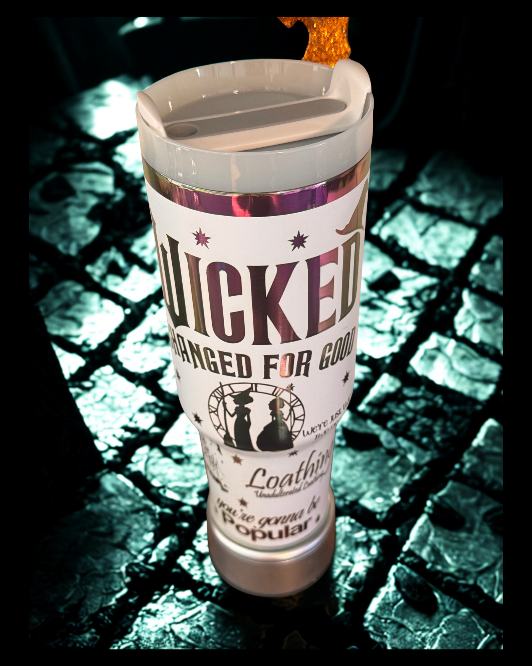 A white tumbler with a printed label that says "Wicked" and " Changed for good".